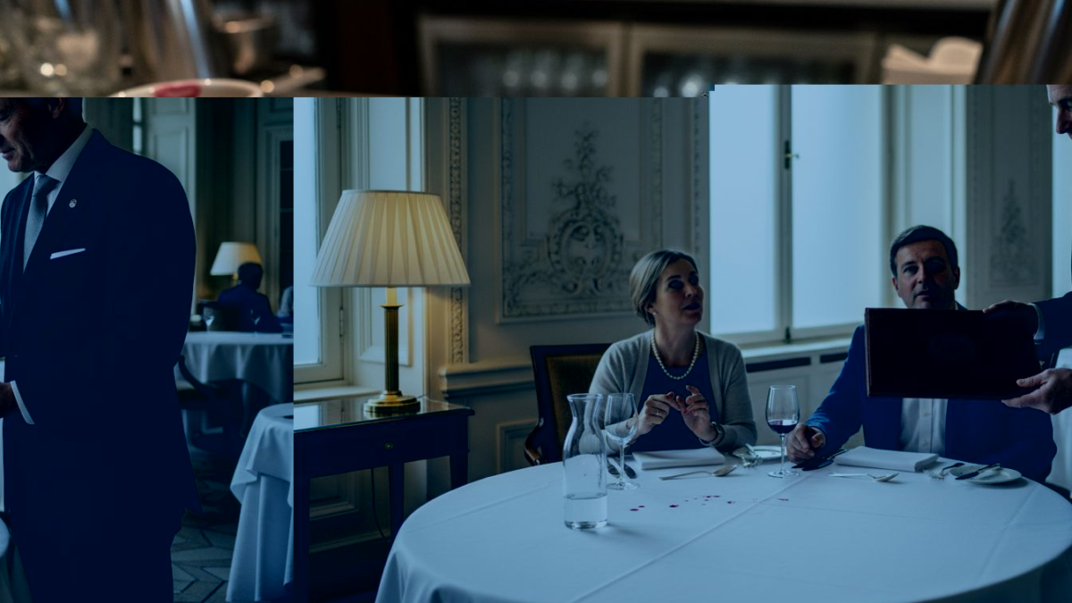 Maître d’ presenting luxury menu cover in grand dining room