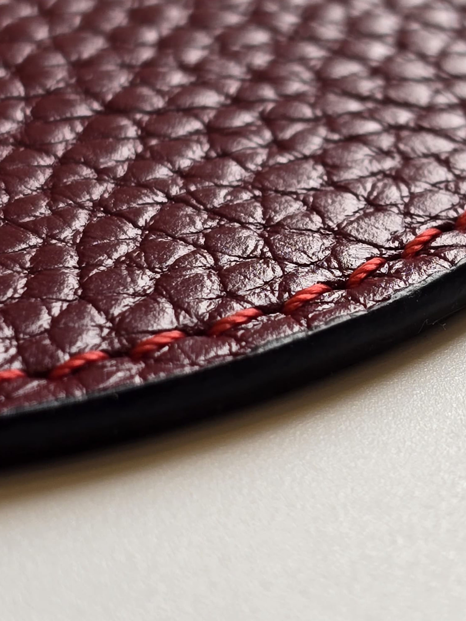 Precision stitching detail on handcrafted leather coaster