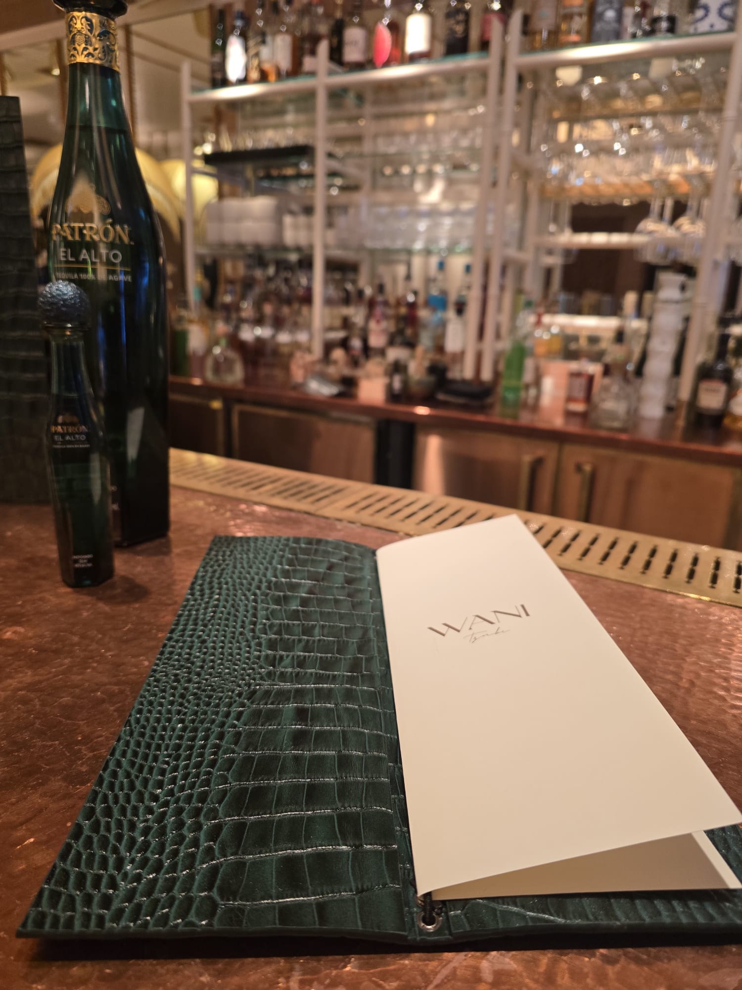 Green crocodile embossed leather menu cover for Louie Covent Garden