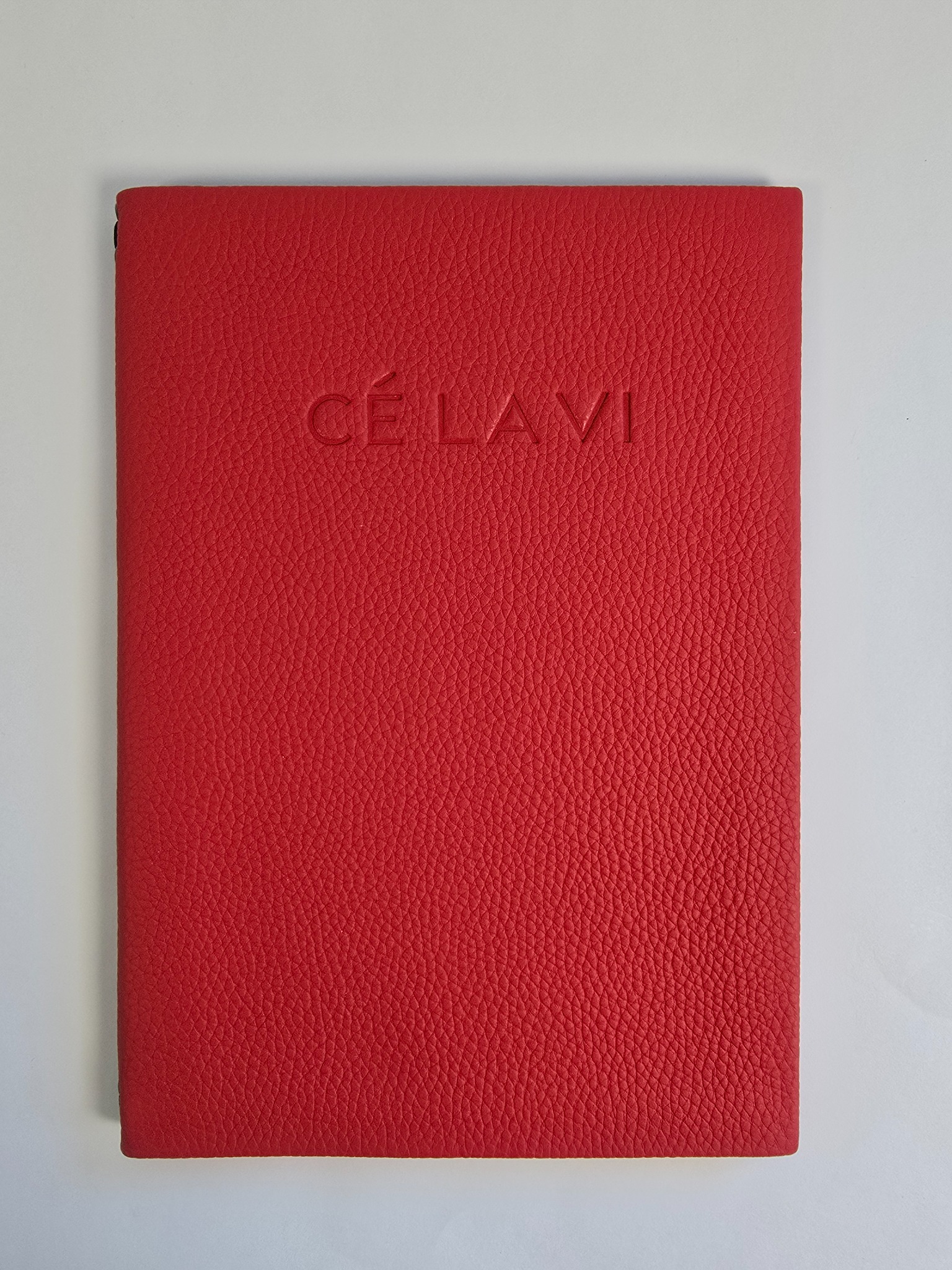 Red leather menu cover with embossed branding for CE LA VI London